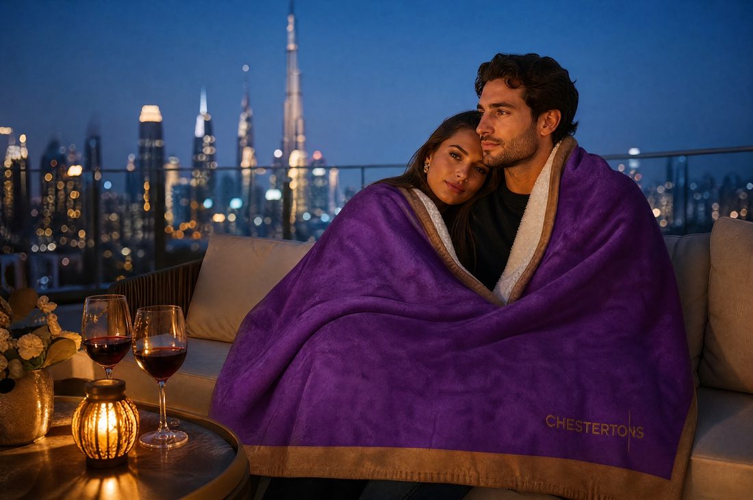 Couple sharing the blanket on a terrace above the city at night