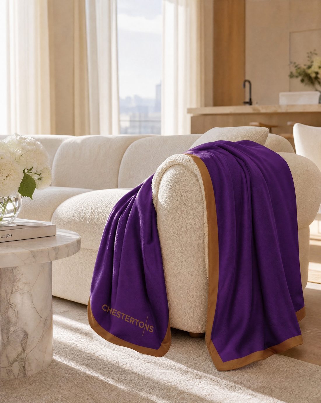 Blanket draped over the arm of a boucle sofa
