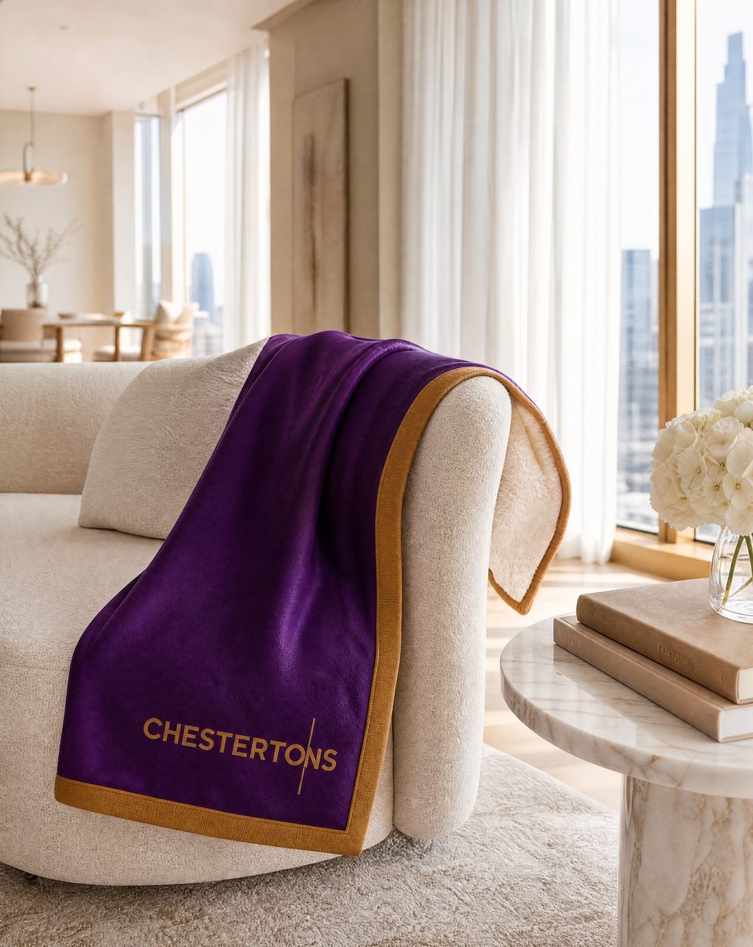Blanket draped over an armchair with the logo in view