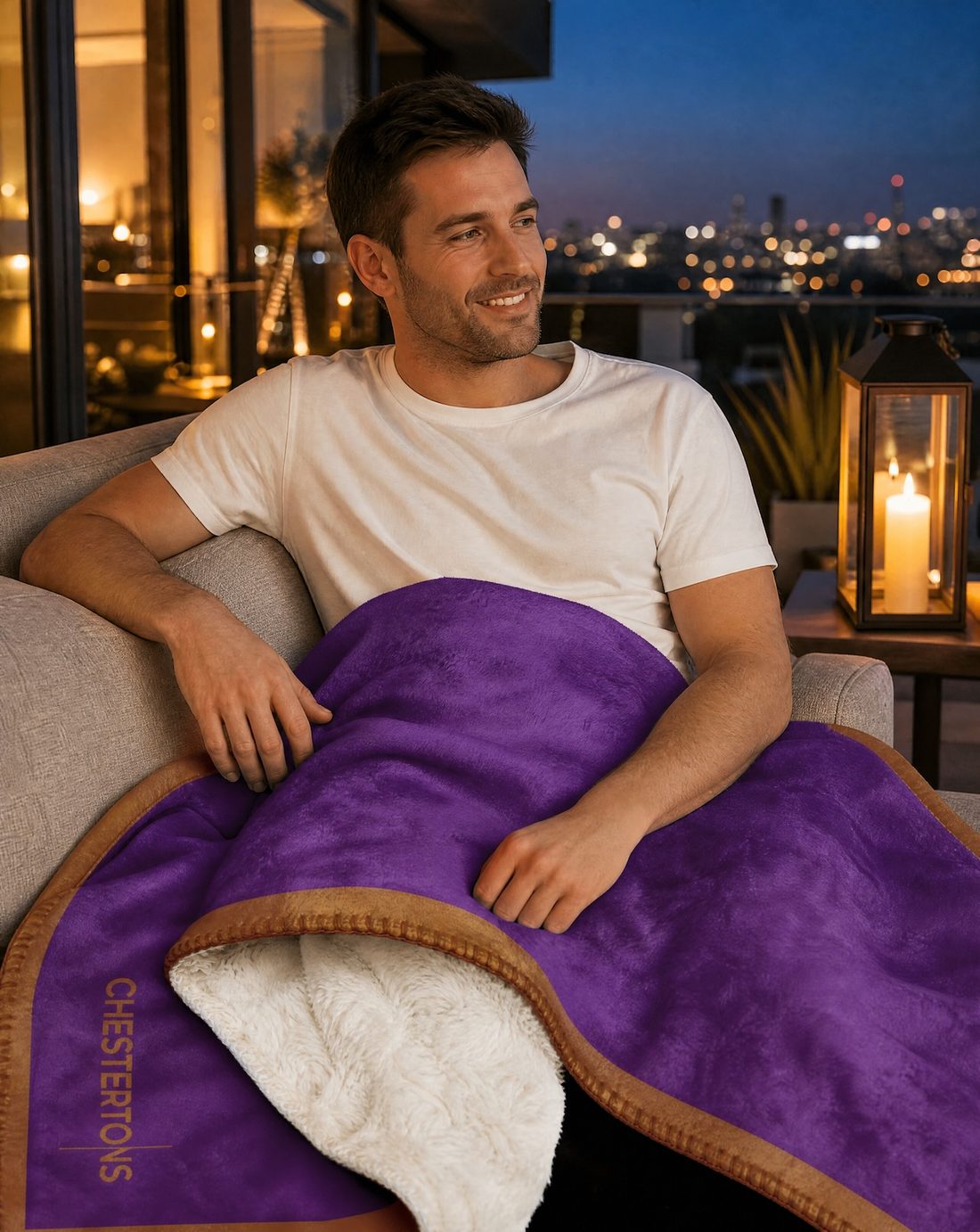 Man relaxing with the blanket over his lap on a terrace at dusk