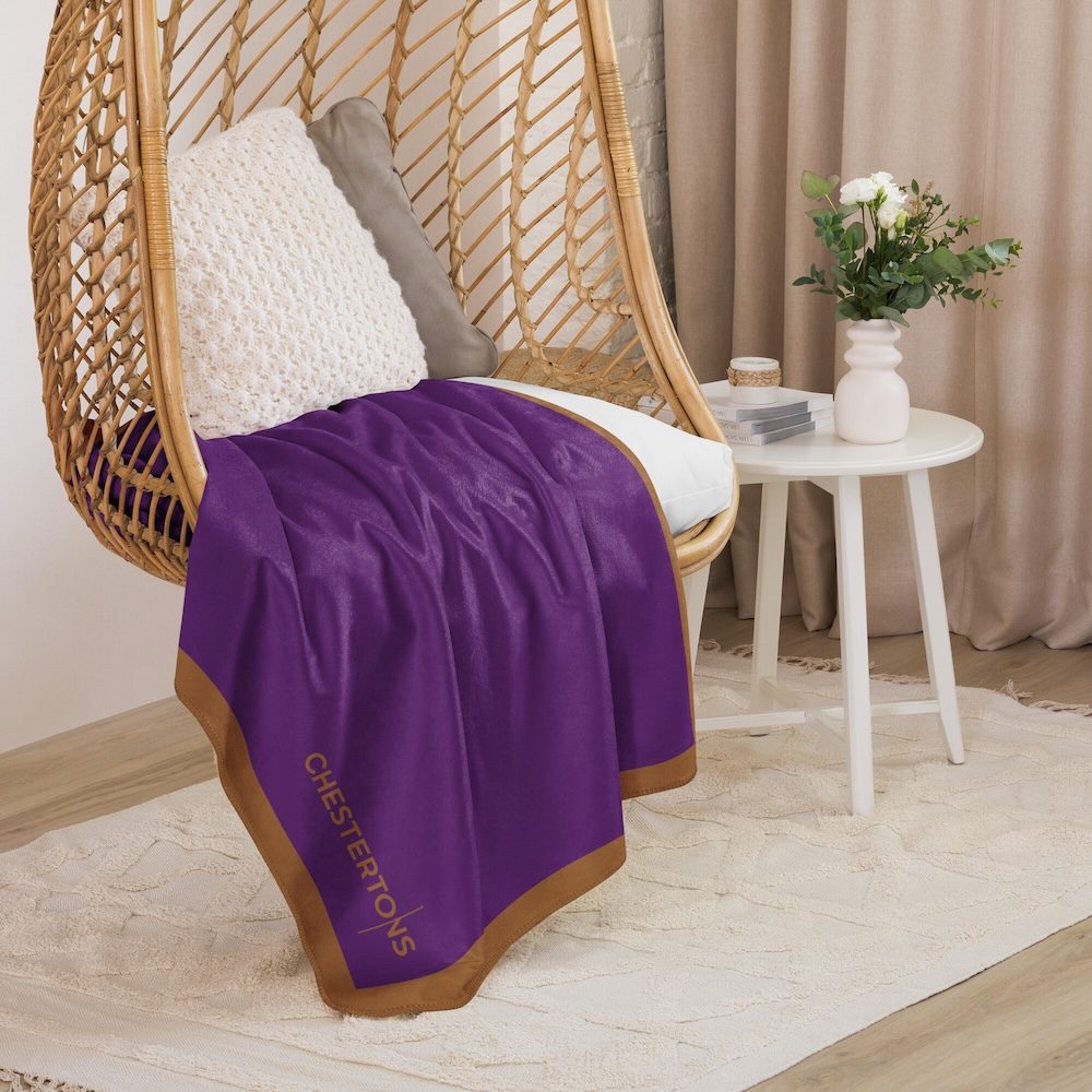 Blanket on a rattan hanging chair in a calm interior